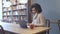 Casual student woman sitting at coffee shop and using laptop