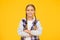 Casual style. Little girl yellow background. Good mood concept. Positive vibes. Self confidence. Cute braided girl. Kid
