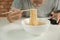 Casual Thai man uses chopsticks to eat instant noodles in a white cup