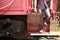 Casual tourist with a retro suitcase getting off the train.