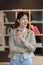 Casual woman with arms crossed at bright smiling office standing in front of her office.