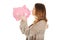 Casual woman kissing piggy-bank.