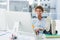 Casual young man with legs on desk in bright office