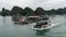Cat Ba, Vietnam - November 19, 2019 : Fishing boat passes floating village
