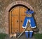 Cat in blue cloak at gate of castle