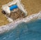 Cat in blue mask sleeps on beach of sea