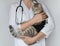 Cat after cavitary operation, castration, sterilization. Veterinarian doctor with stethoscope holding spayed pet in postoperative