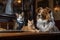 a cat and a dog sitting together on table, being served by wait staff