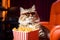 Cat eating popcorn and watching an exciting premiere of a new movie in cinema