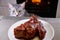 Cat glances at piece meat. Pet watch from behind kitchen table. Gray cat looks at background of kitchen and a large piece meat on