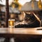 a cat with his paw on a glass of beer in front of him