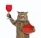 Cat holds red wine and red caviar