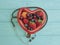 Cat homeless eats on the streetfruit strawberry, blueberry, cherry, apricot plate heart on blue wooden, stethoscope