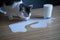 Cat licking milk spilled on a table from a glass