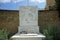 A cat lies in the shadows on a marble monument in Lardos, Rhodes Island, Greece