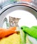 Cat looking inside wash machine with interest