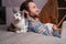 Cat lying on bed next to hugging couple on floor