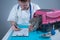 Cat in pet carrier on examination table of veterinarian clinic with pet doctor. Male veterinarian in white medical suit