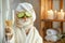 Cat relaxing in spa with cucumber slices on eyes holding a glass of champagne. Cute cat in a bathrobe and turban on spa treatments