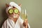 Cat relaxing in spa with cucumber slices on eyes holding a glass of champagne. Cute cat in a bathrobe and turban on spa treatments