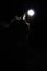 Cat silhouette enlightened by lantern in dark room.