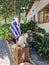 A cat sits on a cut tree bark next to a Greek flag in Makrinitsa, Pelion