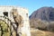 Cat sitting on railing on Rocca D`Anfo