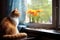 cat sitting on a windowsill, watching fish in a nearby tank