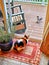 Cat and squirrel eyeing each other through a sliding glass door