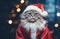 Cat wearing Santa Claus costume on Christmas glittering lights