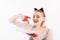 cat woman lick milk from plate. Food and drink. Girl in kitten ears and red gloves with yoghurt isolated on white