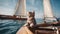 cat on the yacht A brave little kitten with a soft, striped coat, sailing the calm sea waves in a sturdy little boat