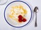 Catalan whey cheese, mato, served on plate with raspberries and honey