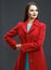 Catalog clothes style photo of fashion model dressed in red coa