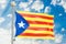 Catalonia flag waving in blue cloudy sky, 3D rendering