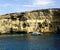 Catamaran at anchor below the cliffs of Comino