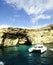 Catamaran at anchor below the cliffs of Comino