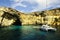 Catamaran at anchor below the cliffs of Comino