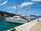 Catamaran docked in a bay with restaurant in Croatia at sunset, Kaprije island