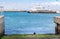 Catamaran docked at harbour on Robben Island with cormorants and