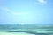 A catamaran moored near a reef on a tranquil ocean.