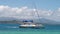 Catamaran motoring in blue waters of the Caribbean against blue sky