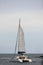 Catamaran sailboat with group of people heading out to the sea