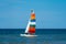Catamaran sailing boat with a very colourful sail