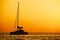 Catamaran sailing at sunset