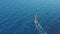 Catamaran ship with bright sheet sails fast along sea