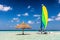 Catamaran on tropical sandbank island with sunshade, Maldives. Indian Ocean