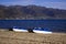 Catamarans boats on a sandy beach in the town of Pogradec against the backdrop of Lake Ohrid