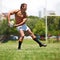 Catch the ball. Full length shot of a shirtless young rugby player executing a pass.