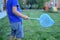 Catching bugs in the backyard with a net